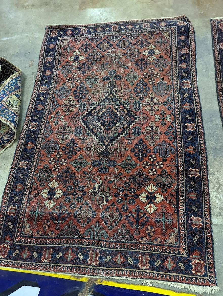 A pair of Caucasian red ground rugs, 200 x 134cm